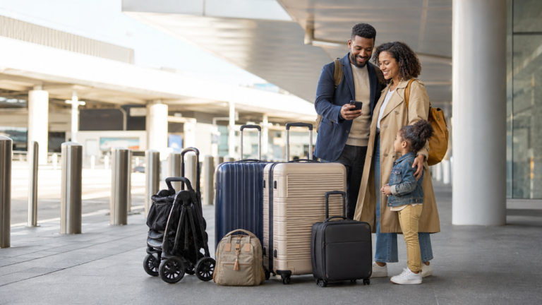 Family with a folded stroller and luggage preparing for an airport pickup